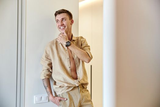 Happy smiling caucasian man in new fresh light apartments