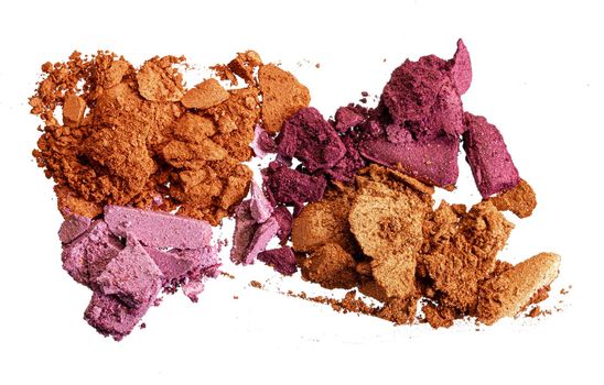 Crushed eyeshadow samples of bright colors isolated on white