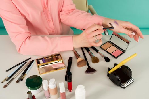 Beauty blogger producing makeup tutorial online translation