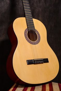 Classical acoustic guitar on a stool vintage