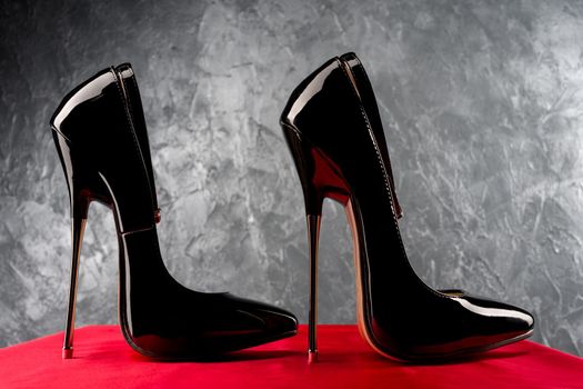 Black fetish shiny patent leather stiletto high heels with ankle strap