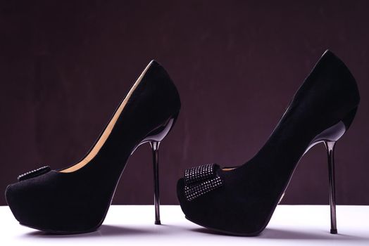 Pair of elegant high heel shoes on background.