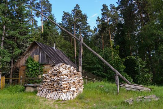 Small hut in the garden with firewood