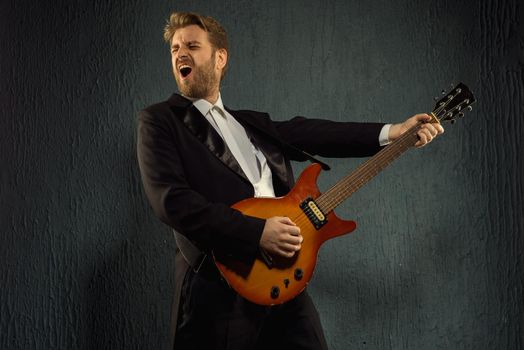 Guitar player with beard and black tailcoat