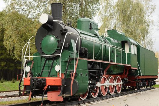 Side view of old green, steam locomotive