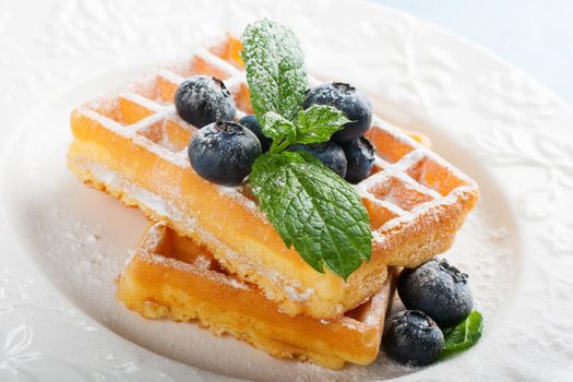 Plate of belgian waffles with fresh berries
