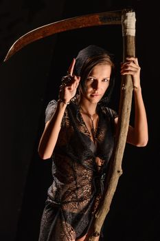 Girl in a black lace smock with scythe of death. 