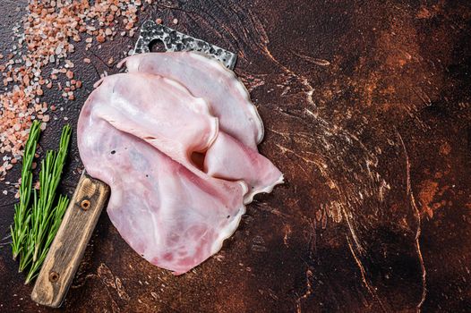 Sliced Ham Prosciutto on a butcher cleaver. Dark background. Top view. Copy space