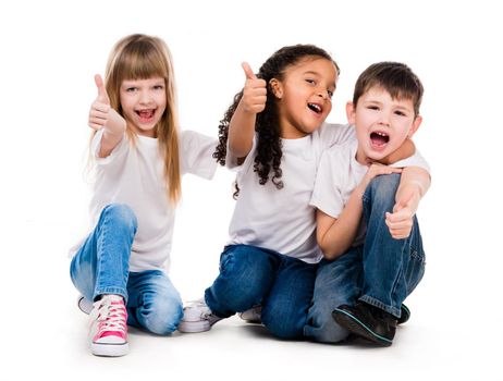 three funny children sitting on the floor with thumbs up