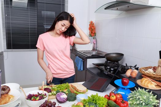 depressed woman cooking in kitchen room
