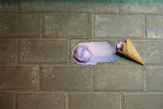 Oops pink ice cream fell down on the ground. Top view with a place for text