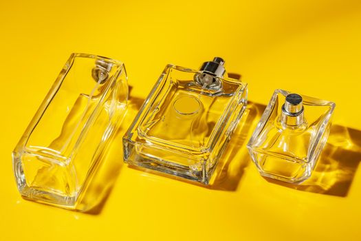 perfume glass bottle on light yellow background. Eau de toilette