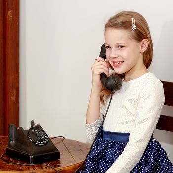 Girl talking on old phone.
