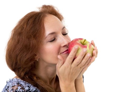 Beautiful woman smelling fresh red apple