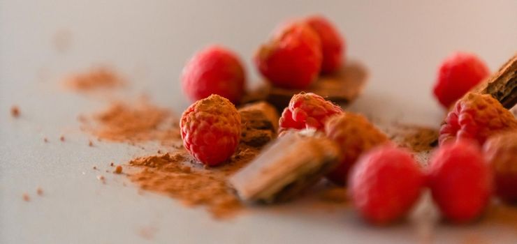 raspberries with chocolate on gray background chocolate