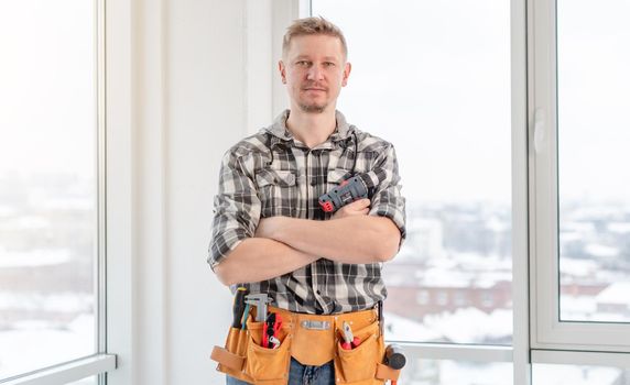Young caucasian worker with tool belt