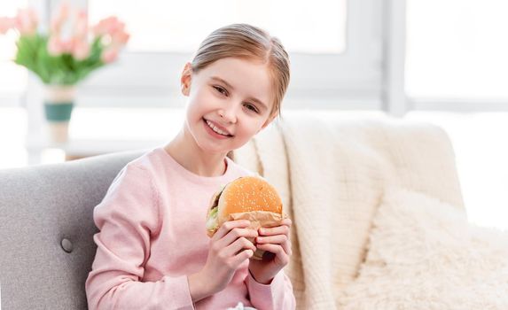 Little girl with hamburger
