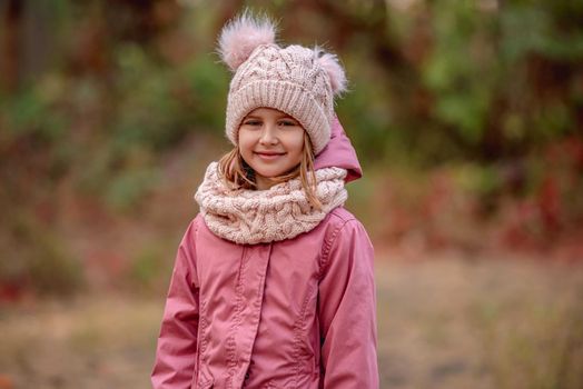 Little girl in knitted scarf and hat