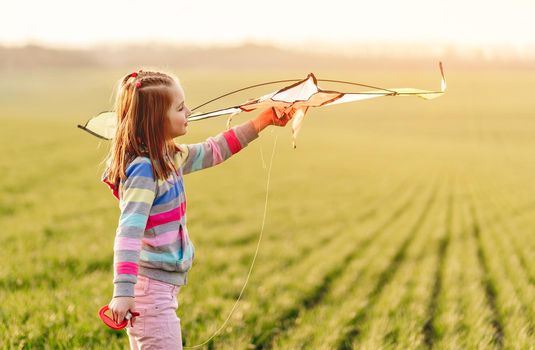 Little girl with flying kite
