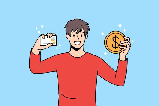 Smiling man hold credit card and bitcoin