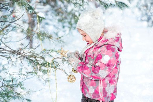 Little girl decorating christmas tree