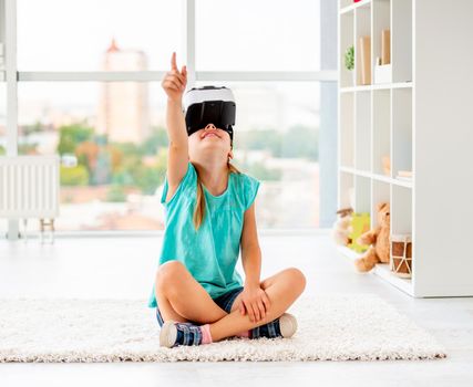 Kid girl playing games in VR headset