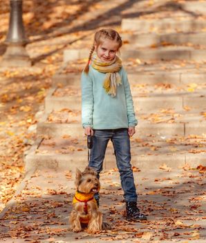 Cute girl with yorkshire terrier