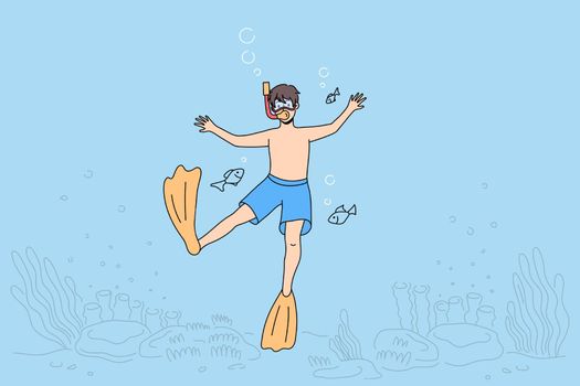 Boy child in swimwear dive snorkel in waters