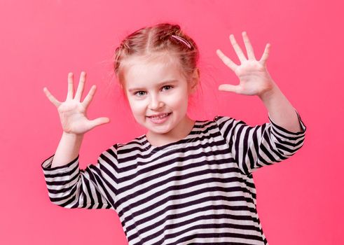 Blonde little girl showing her palms