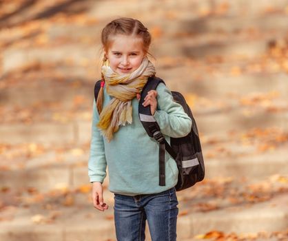 School girl in autumn park