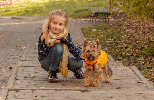 Girl next to yorkshire terrier