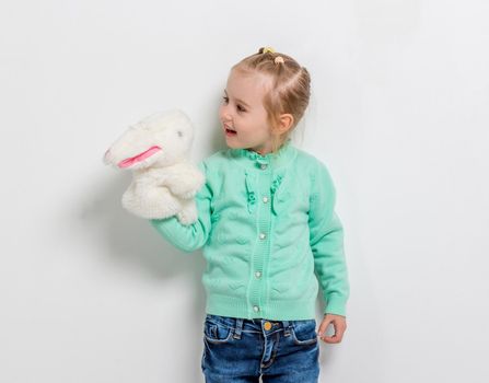 cute smiling girl playing toy hare