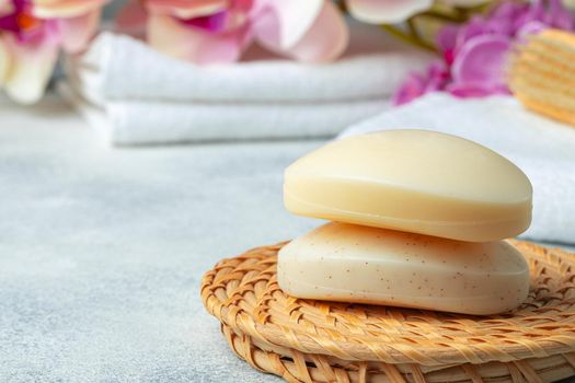 Bar of natural handmade soap, towel and spa objects