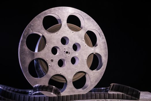 35 mm film reel with dramatic lighting on a dark background
