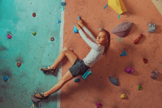 Sporty little girl climbing indoor