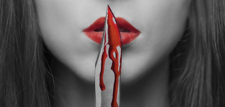 Dangerous woman with knife in blood