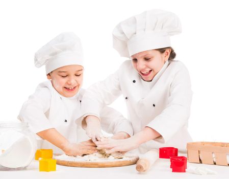 little boy and girl kneating dough