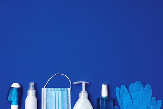 Row of antibacterial protective tools including face mask, gloves, soap and sanitizing gel