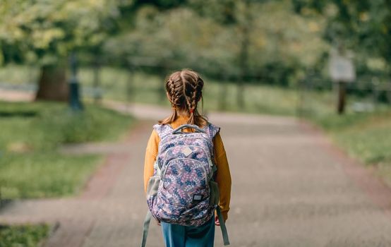 Schoolgirl with backpack outdoors