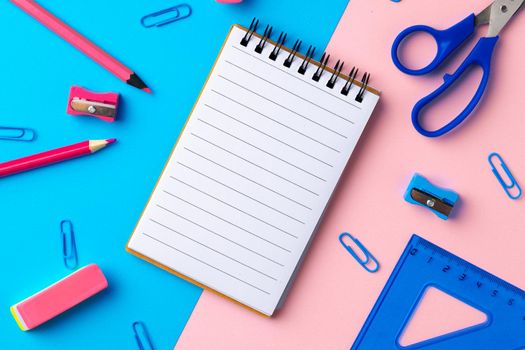 Back to school. Scattered stationery on paper background