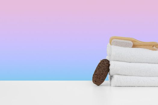 Spa still life with stacked towels and spa stone, front view
