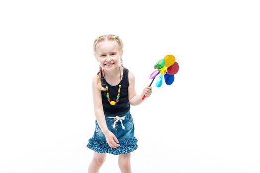 smiling blonde kid with spinning toy wearing tanktop