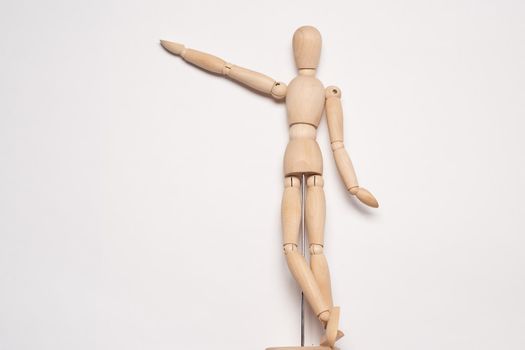 wooden mannequin posing on light background toy object