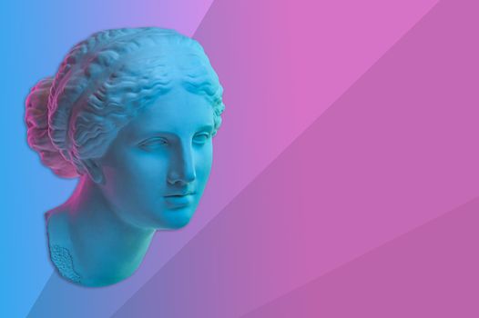 Statue of Venus de Milo. Creative concept colorful neon image with ancient greek sculpture Venus or Aphrodite head. Webpunk, vaporwave and surreal art style. Pink and blue duotone effects.