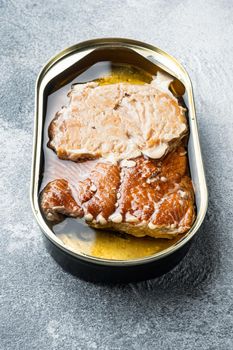 Canned Smoked Trout Fillets, in tin can, on gray background