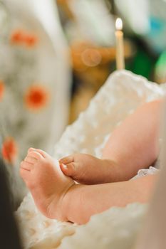 Baptism of a baby, close up of tiny baby feet, sacrament of baptism.2020