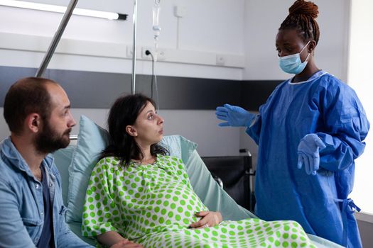 Woman with pregnancy talking to obstetrics nurse