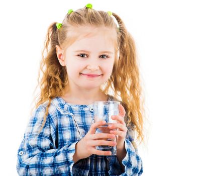 Little baby girl holding a glass of pure water