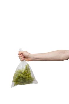 polythene bag held in hand isolated on white. man holding packet of fresh grape