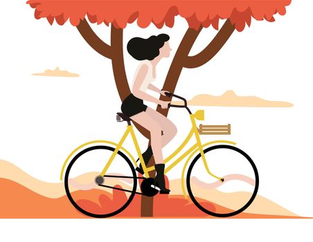 Autumn woman riding a bicycle with tree